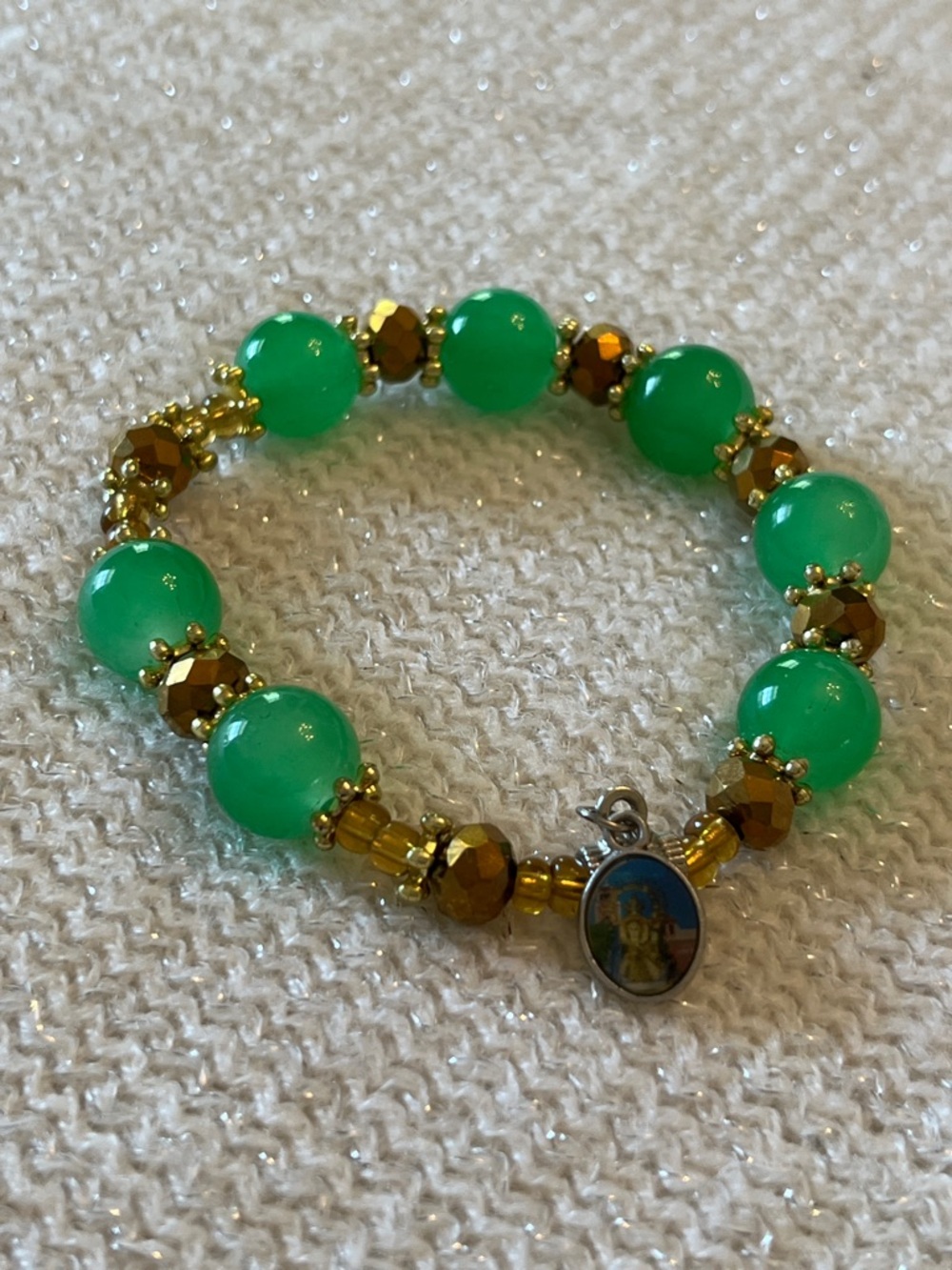 Green Bead Stretch Bracelet with Gold Accents and Religious Charm